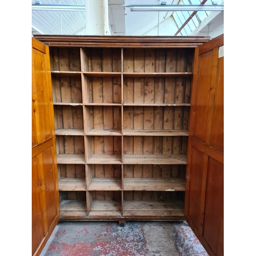 1134 - A late 19th/early 20th century pine school cupboard - approx. 187cm high x 153cm wide x 38cm deep