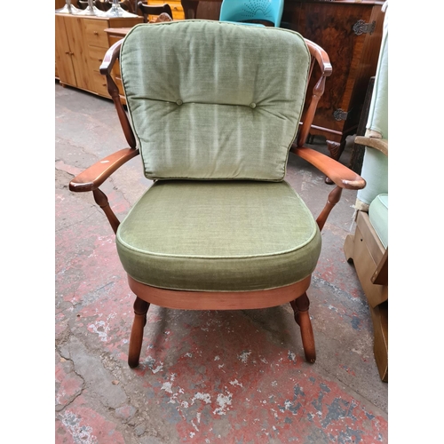 1158 - Two mid/late 20th century beech and green upholstered chairs, one Ercol style armchair and one rocki... 