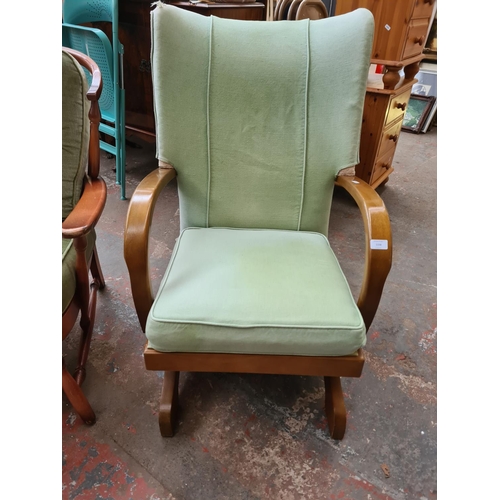 1158 - Two mid/late 20th century beech and green upholstered chairs, one Ercol style armchair and one rocki... 