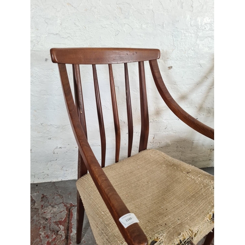 1169 - A pair of mid 20th century teak carver dining chairs