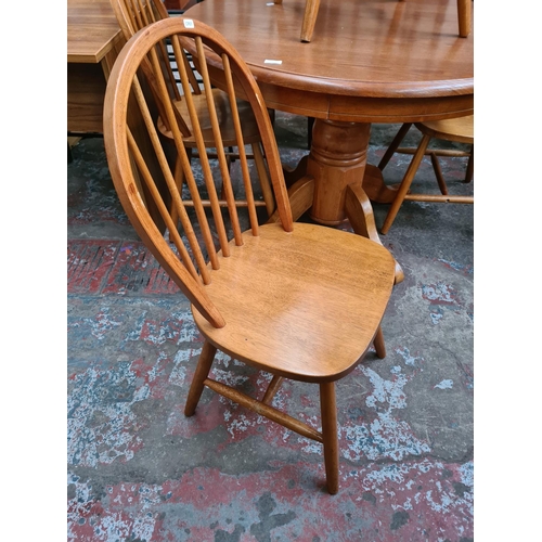 1171 - A modern oak and beech circular pedestal dining table with four beech spindle back dining chairs - a... 