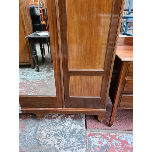 1176 - An Edwardian mahogany double wardrobe with central bevelled edge mirror - approx. 204cm high x 146.5... 