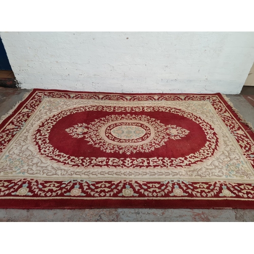 1217 - An Indian red and white rug - approx. 287cm x 187cm