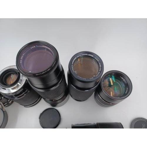 1267 - A large quantity of camera lenses and accessories to include Vivitar 28-200mm 1:3.5-5.3 MC macro foc... 