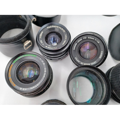 1267 - A large quantity of camera lenses and accessories to include Vivitar 28-200mm 1:3.5-5.3 MC macro foc... 