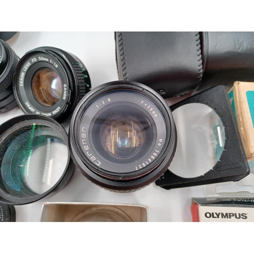 1267 - A large quantity of camera lenses and accessories to include Vivitar 28-200mm 1:3.5-5.3 MC macro foc... 