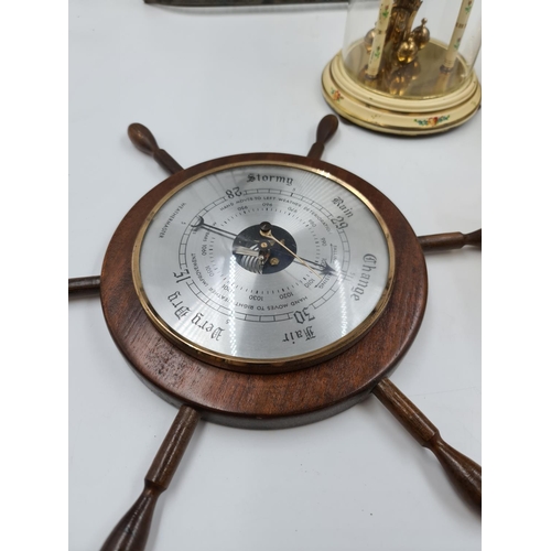 639 - Six assorted clocks and barometers to include novelty ships wheel barometer, Kundo anniversary clock... 