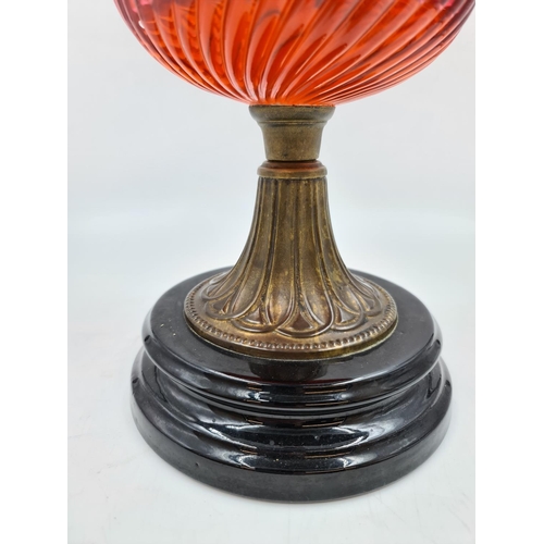 645 - A Victorian cranberry glass and brass oil lamp - approx. 46cm high