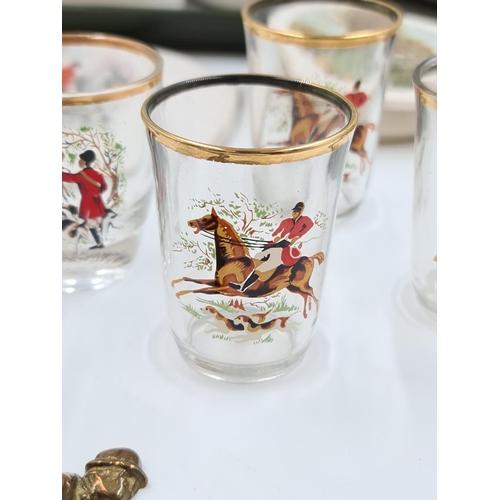 484 - A collection of various hunting scene items to include shot glasses, china mugs, copper hunting horn... 