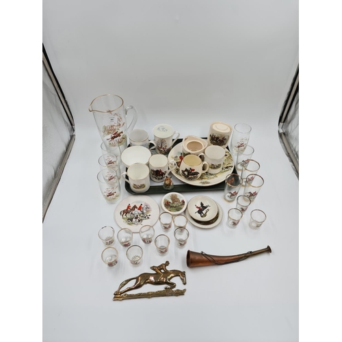 484 - A collection of various hunting scene items to include shot glasses, china mugs, copper hunting horn... 