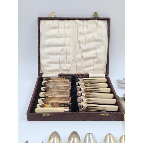 505 - A large collection of assorted vintage cutlery to include hallmarked Sheffield sterling silver tea s... 