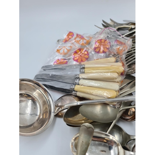 511 - A large collection of assorted vintage cutlery to include WMF 90 ladle, EPNS etc.