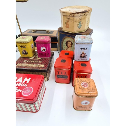 517 - A collection of assorted items to include vintage novelty tins, early 20th century postal scale etc.