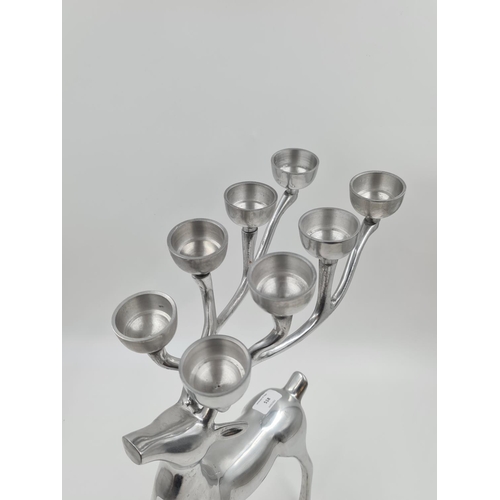 518 - A contemporary metal stag design eight place candle holder - approx. 51cm high x 30cm long