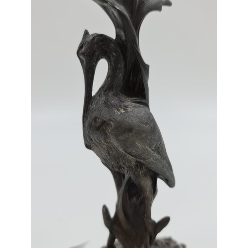 521 - An Art Nouveau E.G. Zimmermann cast metal candle holder with stork design - approx. 25cm high