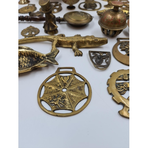 524 - A collection of assorted brassware to include novelty paperweights and ornaments, Victorian tri foot... 