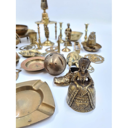 524 - A collection of assorted brassware to include novelty paperweights and ornaments, Victorian tri foot... 