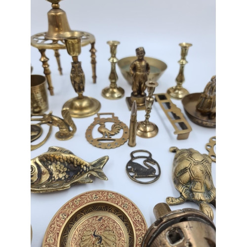 524 - A collection of assorted brassware to include novelty paperweights and ornaments, Victorian tri foot... 