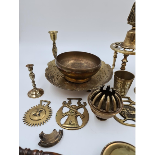 524 - A collection of assorted brassware to include novelty paperweights and ornaments, Victorian tri foot... 