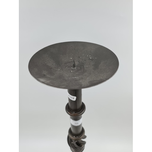 526 - A 19th century style metal tri footed candle holder - approx. 73cm high