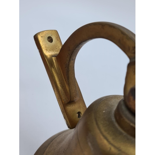 528 - Two items, one Victorian copper kettle with acorn finial and one brass wall mountable bell