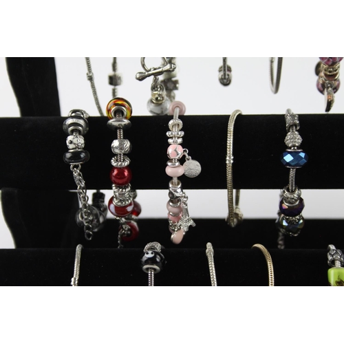 225 - Twenty contemporary fashion charm bracelets