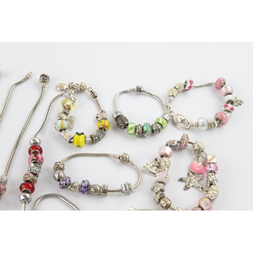 231 - Twenty contemporary fashion charm bracelets