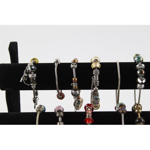 234 - Twenty contemporary fashion charm bracelets