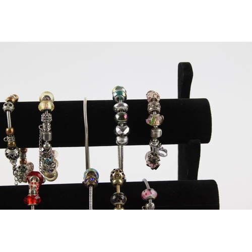 234 - Twenty contemporary fashion charm bracelets