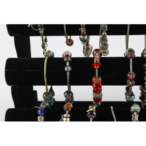 234 - Twenty contemporary fashion charm bracelets