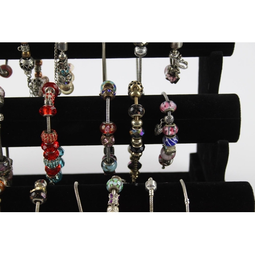 234 - Twenty contemporary fashion charm bracelets