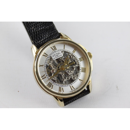 262 - A boxed gents Rotary quality gold tone automatic wristwatch with skeletonised movement and black liz... 