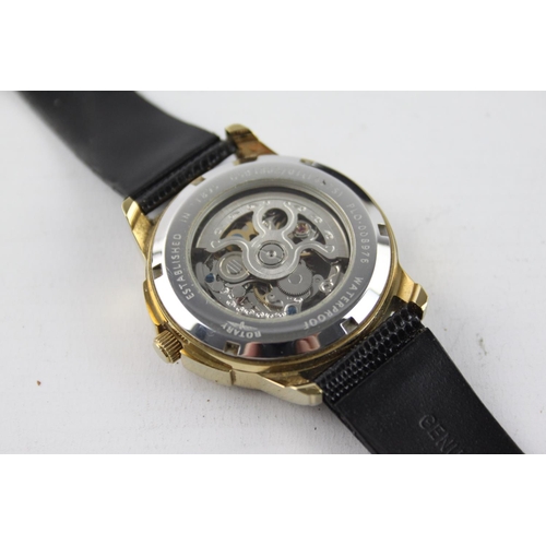 262 - A boxed gents Rotary quality gold tone automatic wristwatch with skeletonised movement and black liz... 