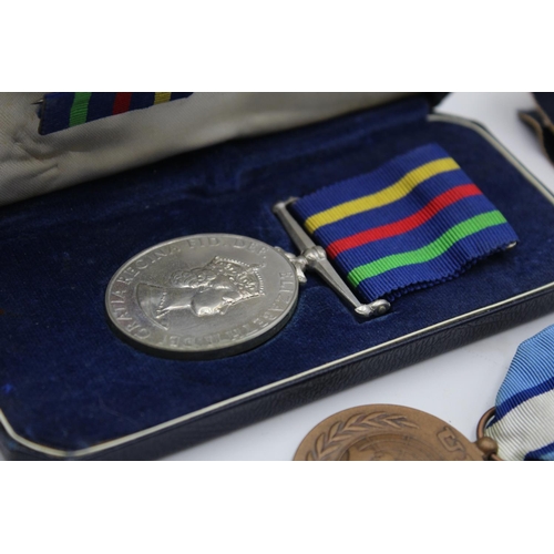 270 - Five assorted medals, one boxed Civil Defence, one Rhodesian medal presented  to PR7415 RFN. R.A. Mi... 