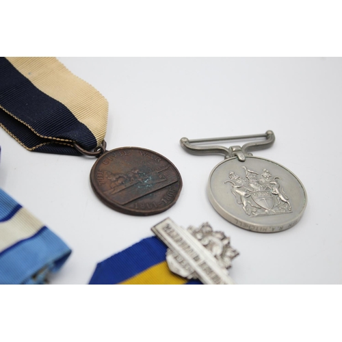 270 - Five assorted medals, one boxed Civil Defence, one Rhodesian medal presented  to PR7415 RFN. R.A. Mi... 