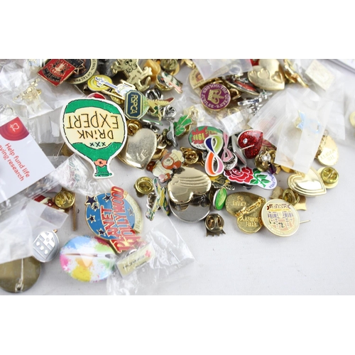 287 - A large collection of assorted vintage lapel and pin badges