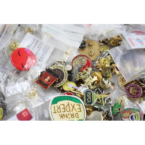 287 - A large collection of assorted vintage lapel and pin badges