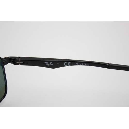 315 - A pair of Ray-Ban black framed rectangular sunglasses with polarized lenses and case