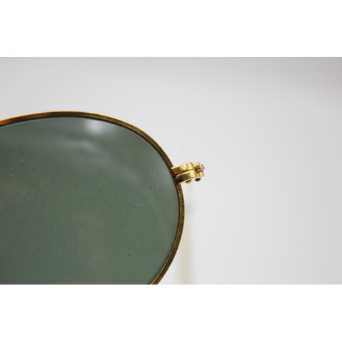 321 - A pair of vintage Bausch & Lomb Ray-Ban gold tone oval sunglasses with case