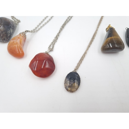 185 - Six various gemstone pendants and pendant necklaces to include compass, tiger's eye, sterling silver... 