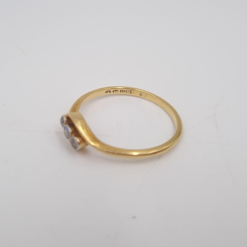 215 - An 18ct gold twist setting diamond trilogy ring, size P½ - approx. gross weight 2.1 grams