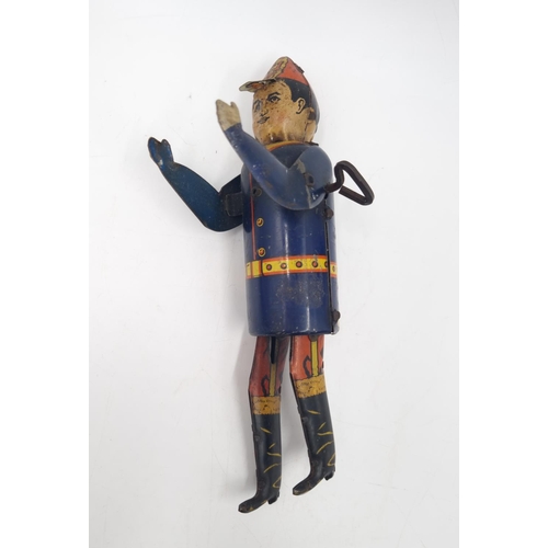 296 - An early/mid 20th century Marx tin plate clockwork climbing fireman toy - approx. 19cm high