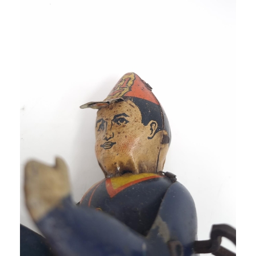 296 - An early/mid 20th century Marx tin plate clockwork climbing fireman toy - approx. 19cm high