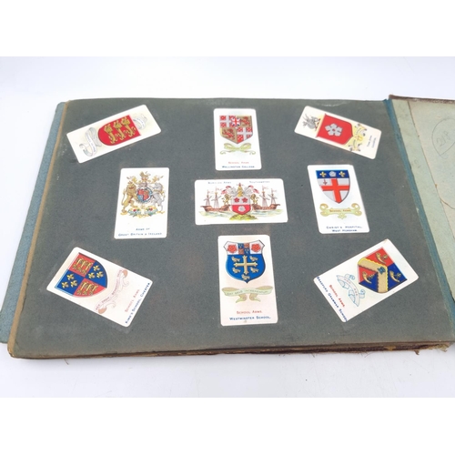 305 - An antique Wills's cigarette card album containing heraldic cigarette cards to include Borough Arms ... 