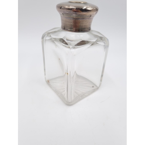 355 - A Victorian cut glass men's cologne bottle with hallmarked London silver top having yellow metal car... 