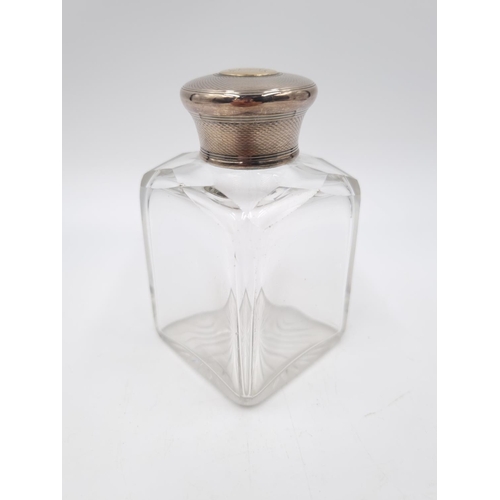 356 - A Victorian cut glass men's cologne bottle with hallmarked London silver top having yellow metal car... 