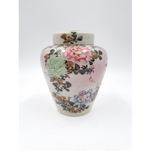 418 - A Japanese porcelain ginger jar and cover decorated with flowers and bird - approx. 14cm high