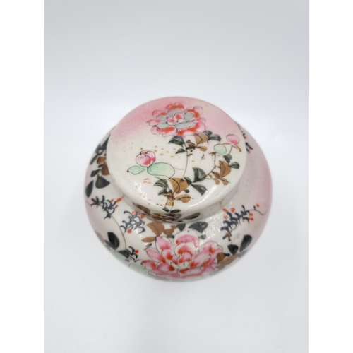 418 - A Japanese porcelain ginger jar and cover decorated with flowers and bird - approx. 14cm high