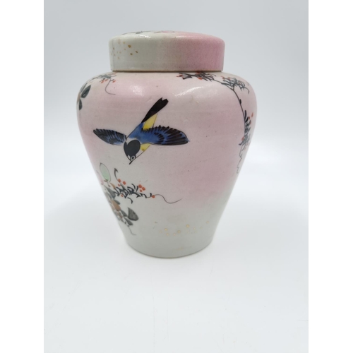 418 - A Japanese porcelain ginger jar and cover decorated with flowers and bird - approx. 14cm high