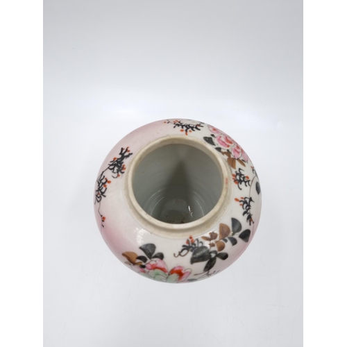 418 - A Japanese porcelain ginger jar and cover decorated with flowers and bird - approx. 14cm high